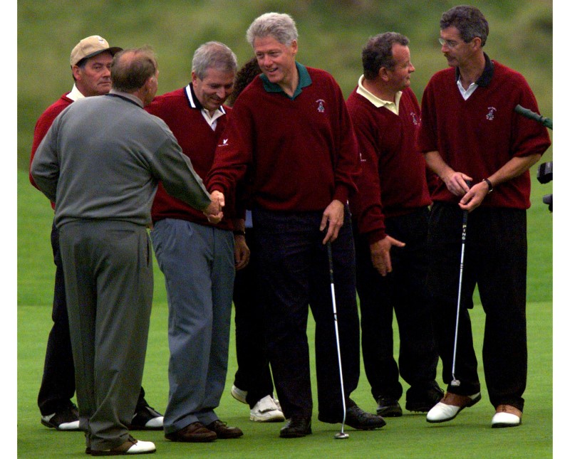 U.S. President Bill Clinton shakes hands with Irish golf legend Christy O'Connor Sr. upon finishing their round of golf at Ballybunion September 5. Clinton will now fly home where a political firestorm awaits him. REUTERS/File